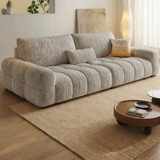 Grey lamb-fleece tufted sofa in a living room
