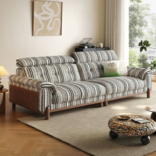 Striped chenille sofa with wooden side panels in a living room