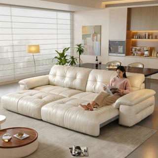 Cream leather power sofa bed in a living room