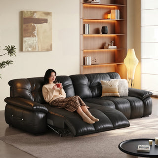 Black leather power recliner sofa in a living room