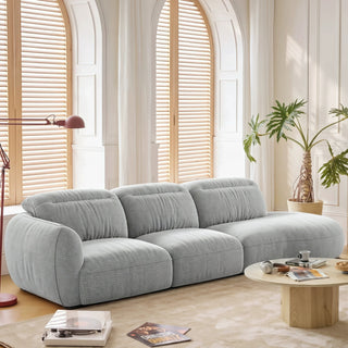 Grey curved fabric sofa in a living room