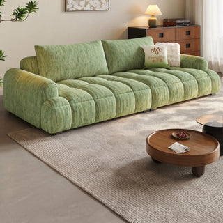 Green chenille puff sofa in a living room