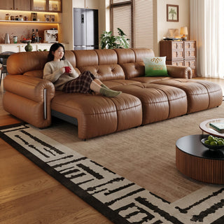 Tan leather power sofa bed in a living room