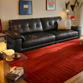 Black tufted leather sofa in a living room