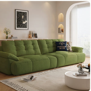 Olive green cat-scratch tufted sofa in a living room