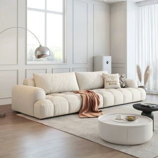 Cream channel-tufted puff sofa in a living room