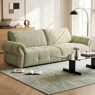Sage green fabric sofa in a living room