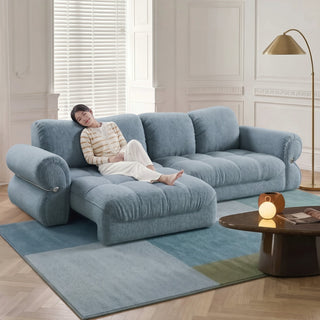 Blue fabric sofa bed in a living room