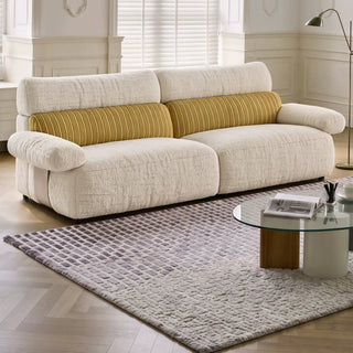 Cream and gold striped chenille sofa in a living room
