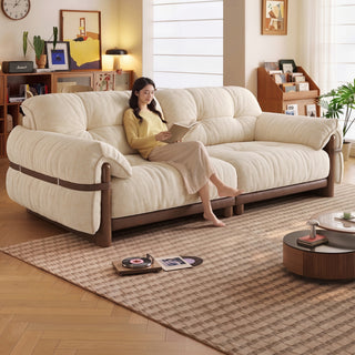 Cream fabric sofa with a wooden frame