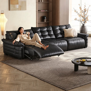 Tufted leather power recliner sofa in a living room