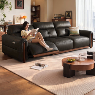 Leather power recliner sofa in a living room