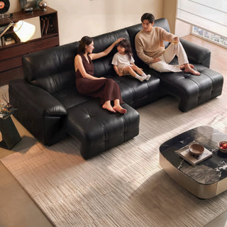 Black leather power sofa bed in a living room