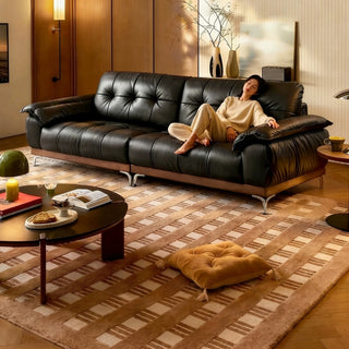 Black leather cloud sofa in a living room