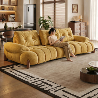 Yellow curved fabric sofa in a living room