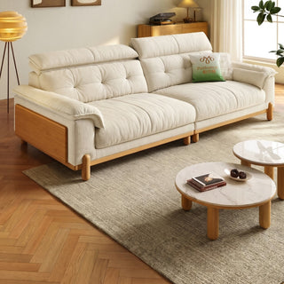 Cream chenille sofa with wooden side panels in a living room