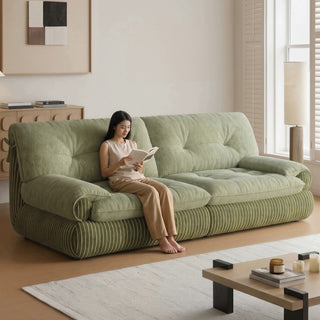 Green chenille sofa in a living room