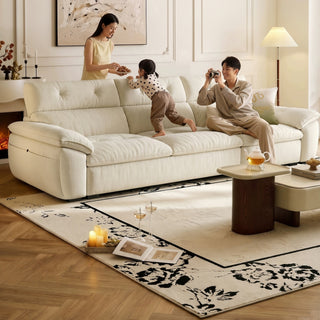Cream fabric sofa with a tufted high back in a living room