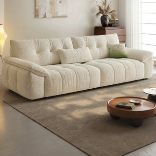 Cream lamb-fleece sofa with tufted back cushions