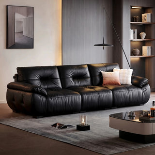 Black pleated leather sofa in a living room