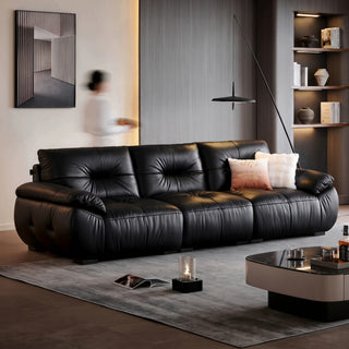Black pleated leather sofa in a living room