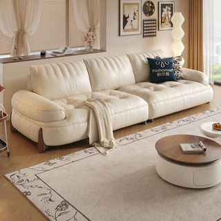 Cream tufted leather sofa in a living room