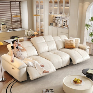 Cream leather power recliner sofa in a living room