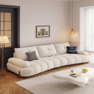 Cream piano-key sofa with oak legs in a living room