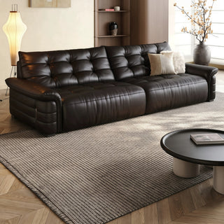 Black tufted leather sofa in a living room