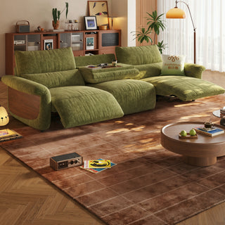 Green velvet power recliner sofa in a living room
