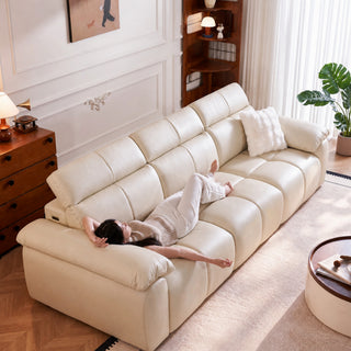 Cream leather power sofa bed in a living room