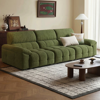 Green tufted fabric sofa in a living room