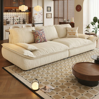 Cream sailboat-style fabric sofa in a living room