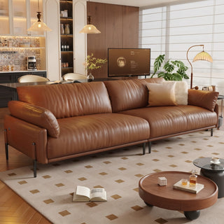 Cognac leather sofa on high legs in a living room