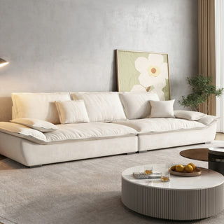 Cream cat-scratch fabric sailboat sofa in a living room