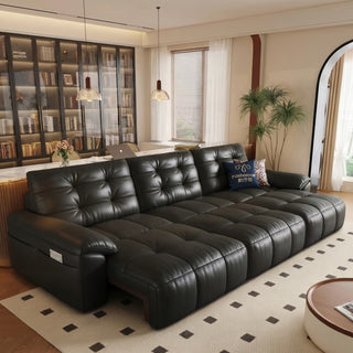 Black leather power sofa bed in a living room