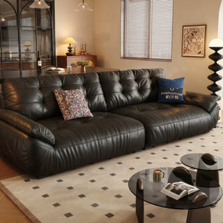 Black leather cloud sofa in a living room