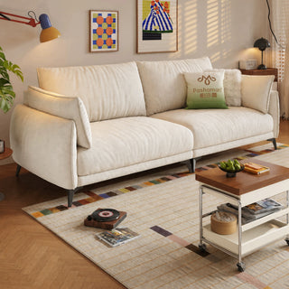 Cream fabric sofa on tall metal legs