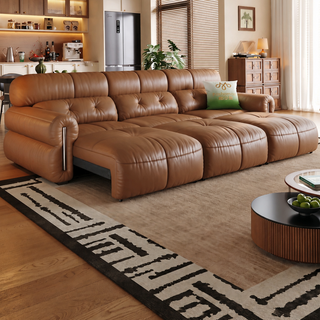 Tan leather power sofa bed in a living room