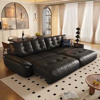 Black leather power sofa bed in a living room