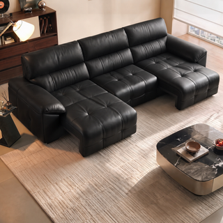Black leather power sofa bed in a living room