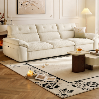 Cream fabric sofa with a tufted high back in a living room