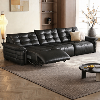 Tufted leather power recliner sofa in a living room