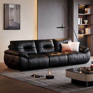 Black hand-pleated leather sofa in a living room