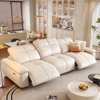 Cream leather power recliner sofa in a living room